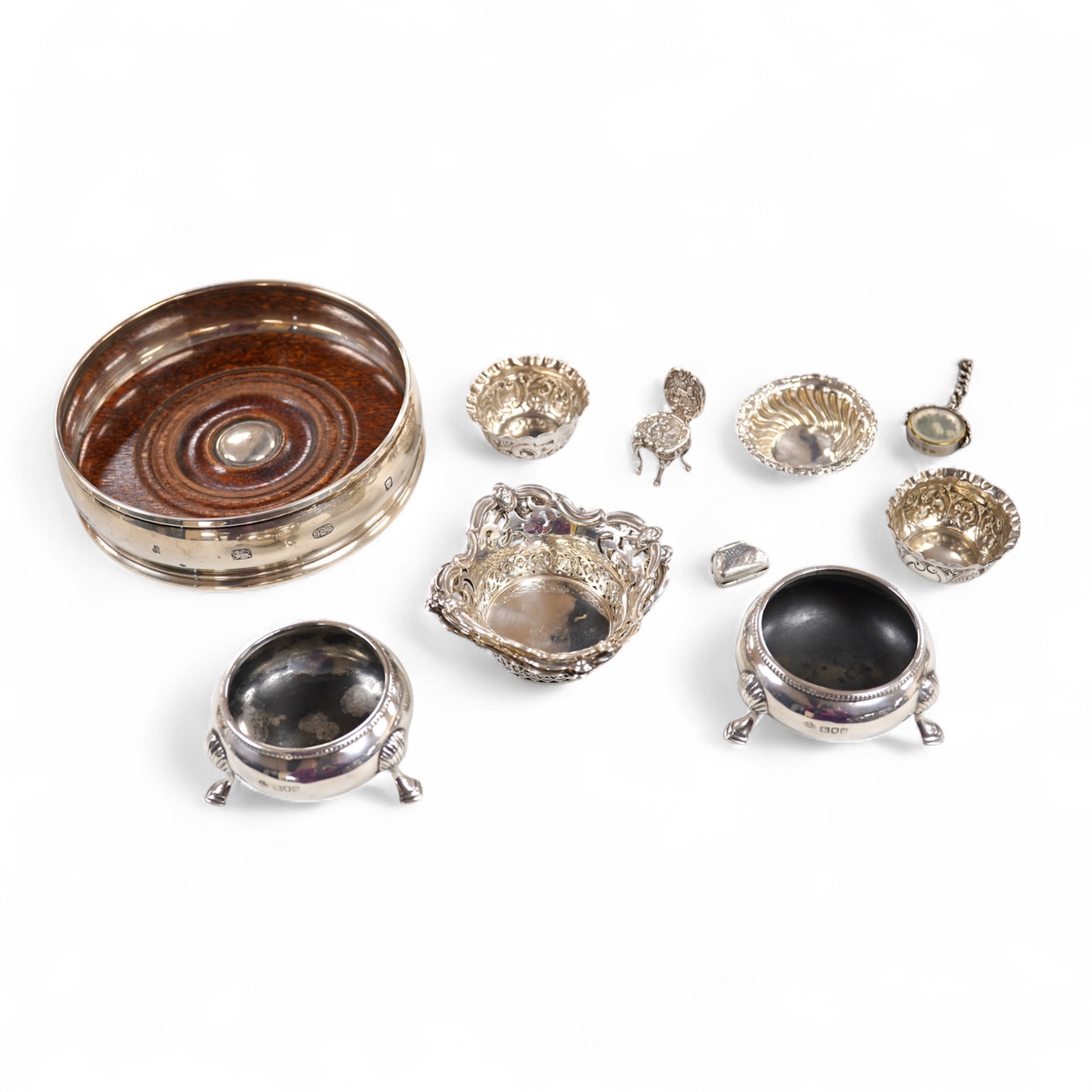 A group of small silver including a modern mounted wine coaster by M C Hersey & Son Ltd, diameter 12.6cm, a set of three George V nut dishes, one other silver nut dish, two pairs of salts including cauldron by William Hu